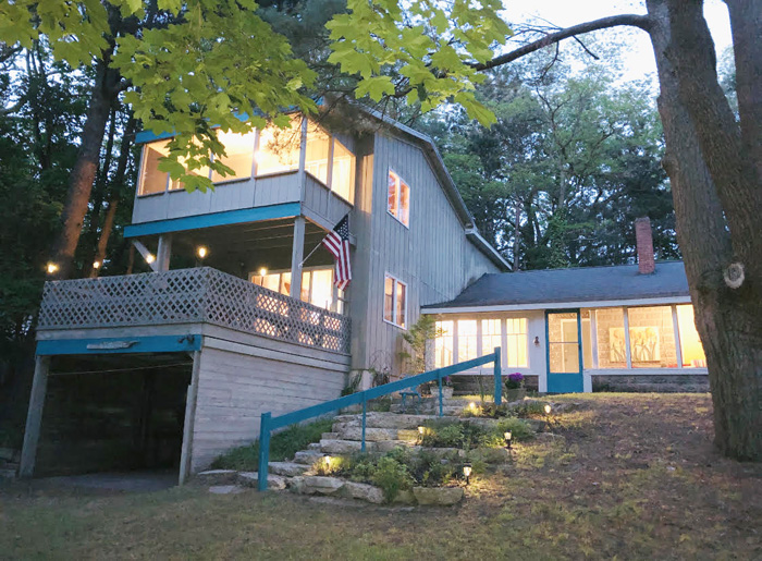 A house with stairs leading to the front of it.