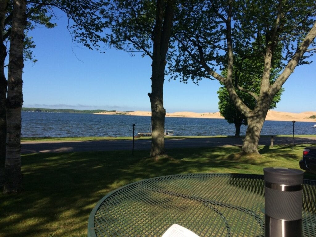 A view of the water from a park bench.