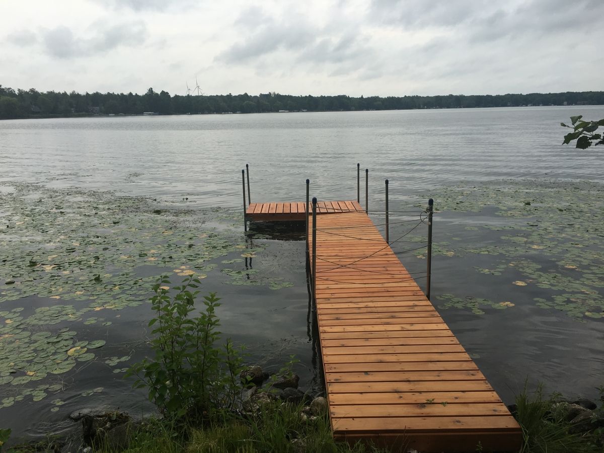 A dock with a wooden walkway going into the water.