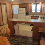 A kitchen with a table and chairs in it