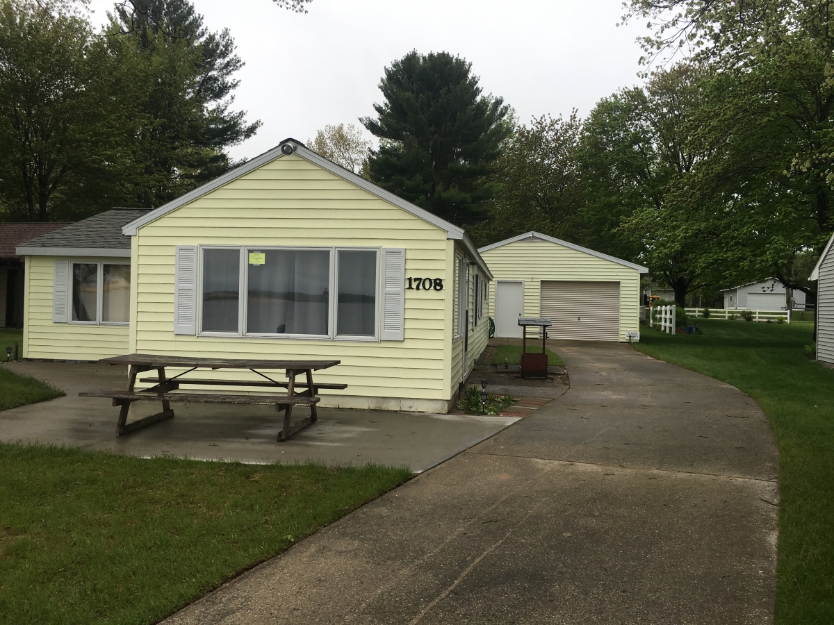 A house with a picnic table in front of it.