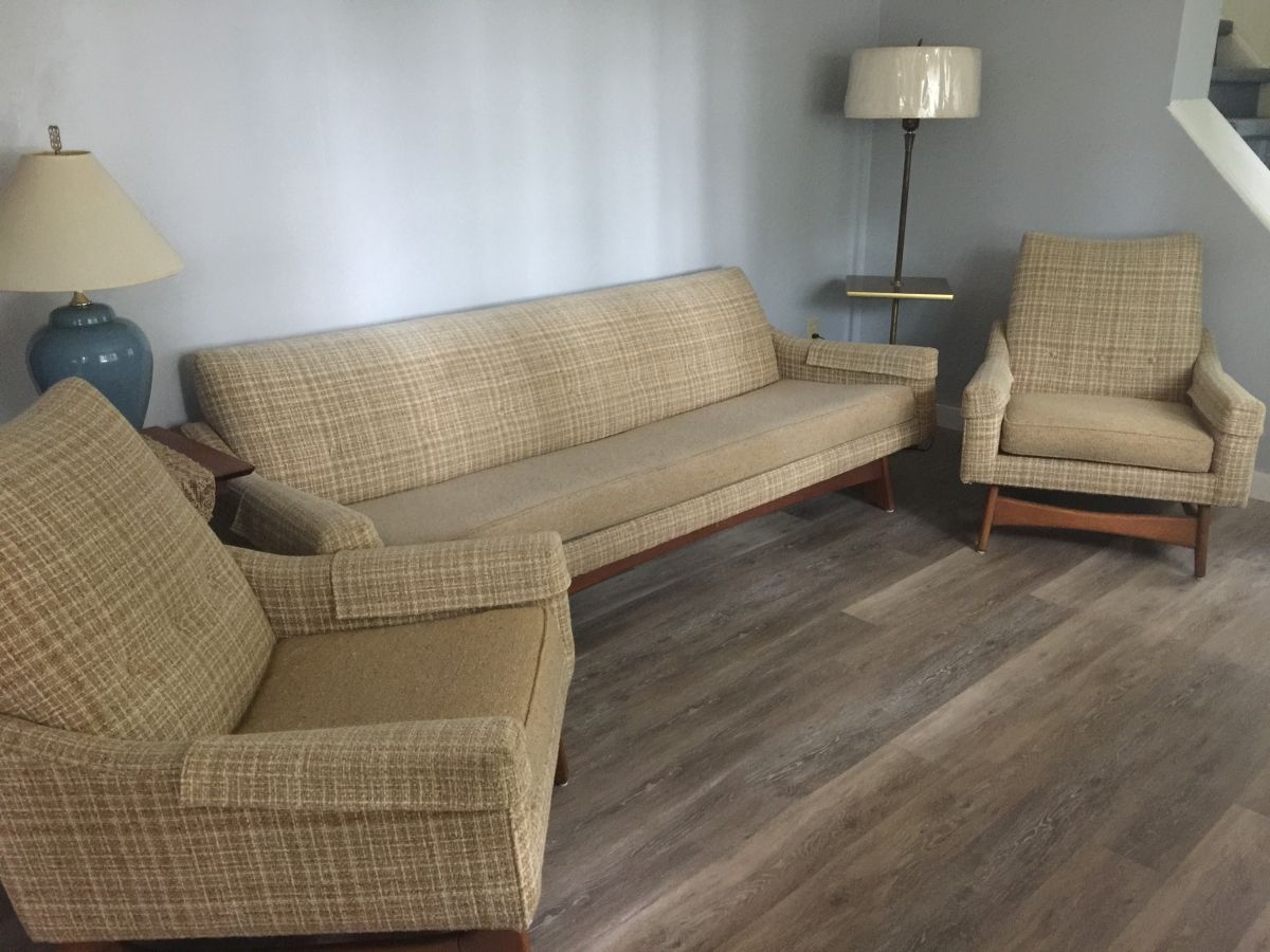 A living room with two chairs and a couch