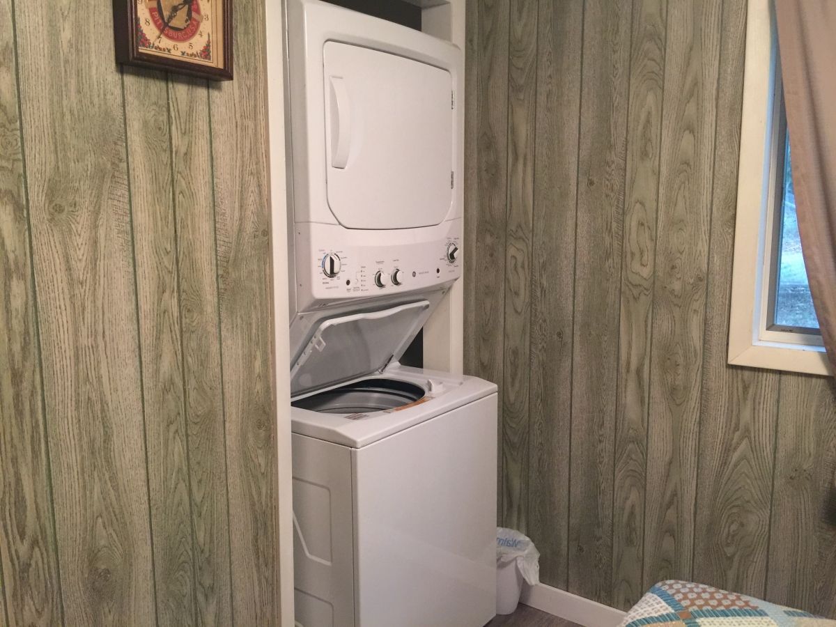 A washer and dryer in the corner of a room.