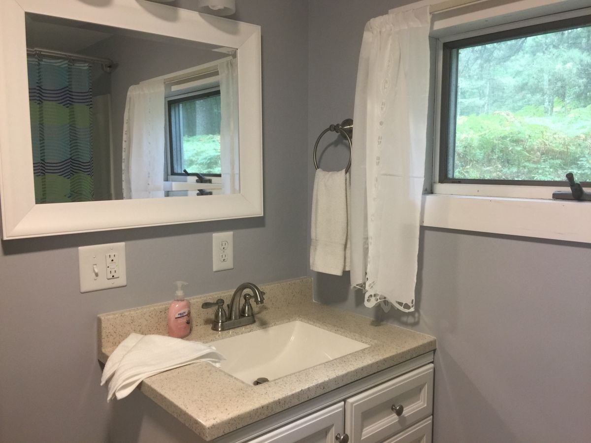 A bathroom with a sink and mirror in it