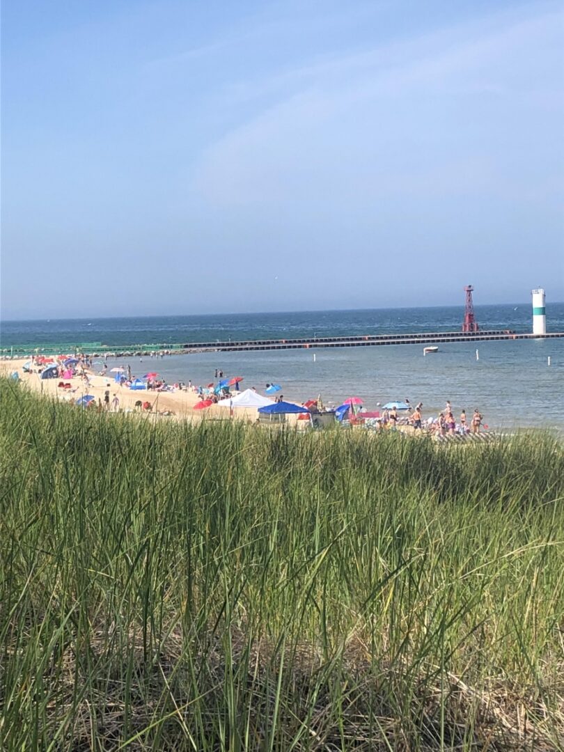 A beach with people on it and some water