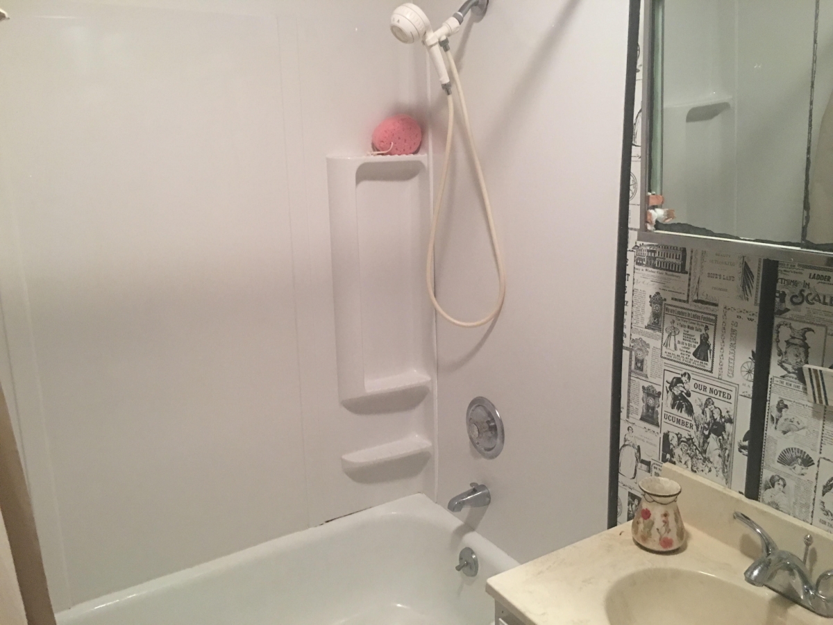 A bathroom with a sink, bathtub and shower.