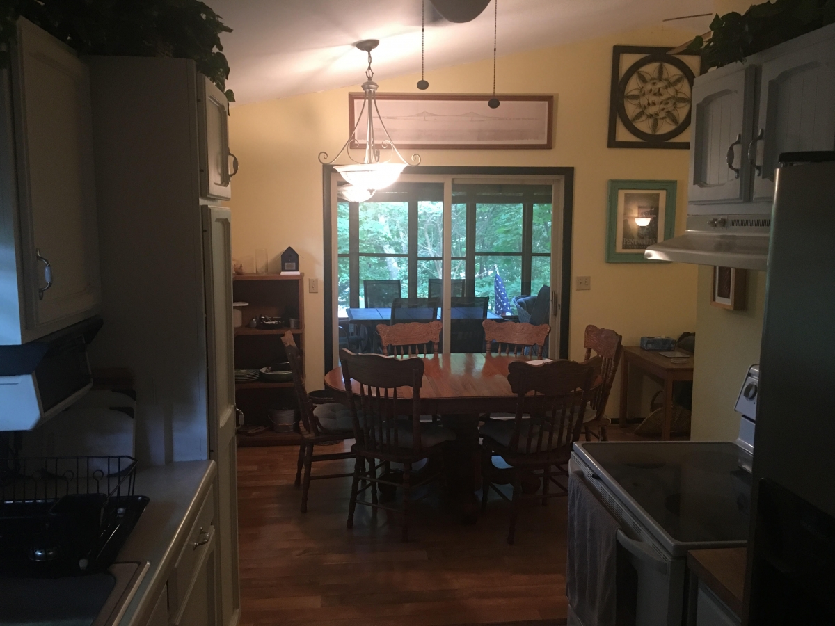 A dining room with a table and chairs in it