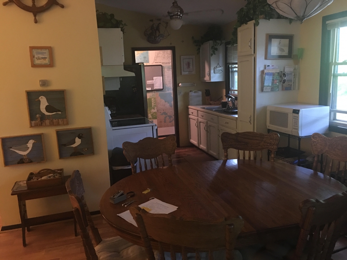 A kitchen with a table and chairs in it