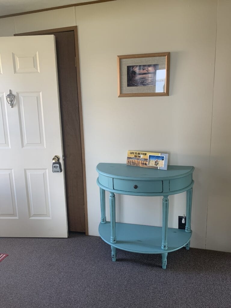 A blue table in the corner of a room.