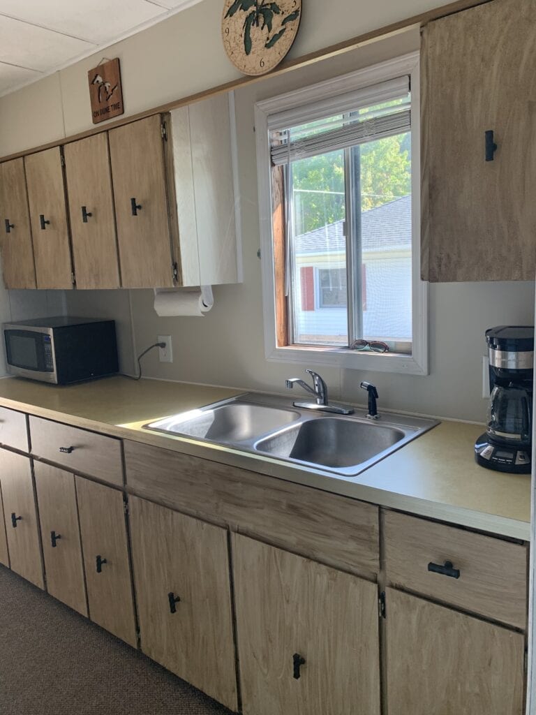 A kitchen with wooden cabinets and a sink.