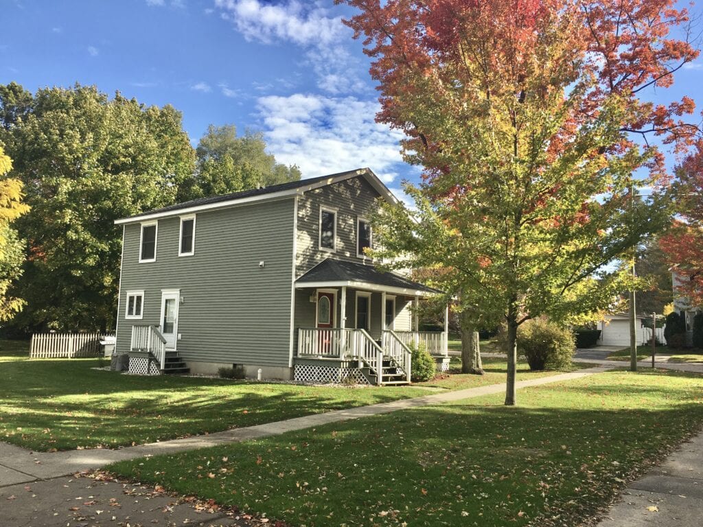 A house with a tree in front of it