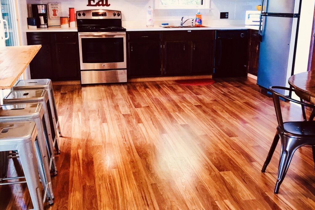 A kitchen with wooden floors and stainless steel appliances.