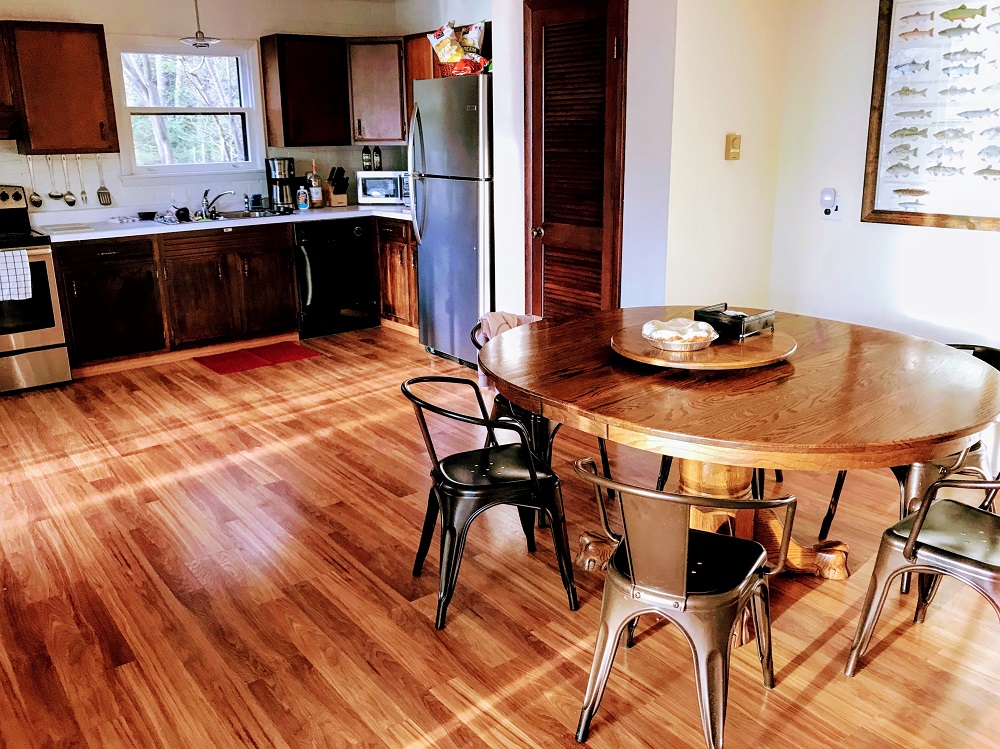 A kitchen with wooden floors and a table