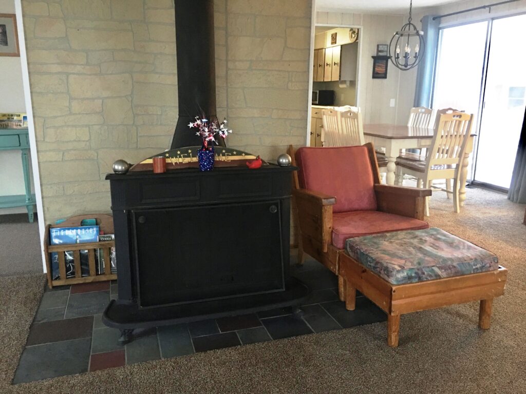 A living room with a fireplace and chairs