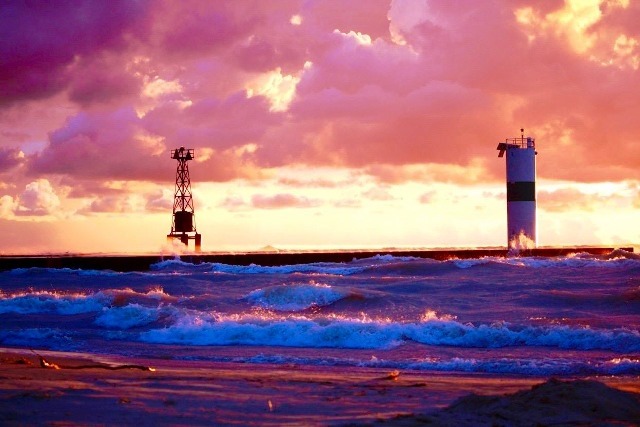 A lighthouse and some waves in the ocean