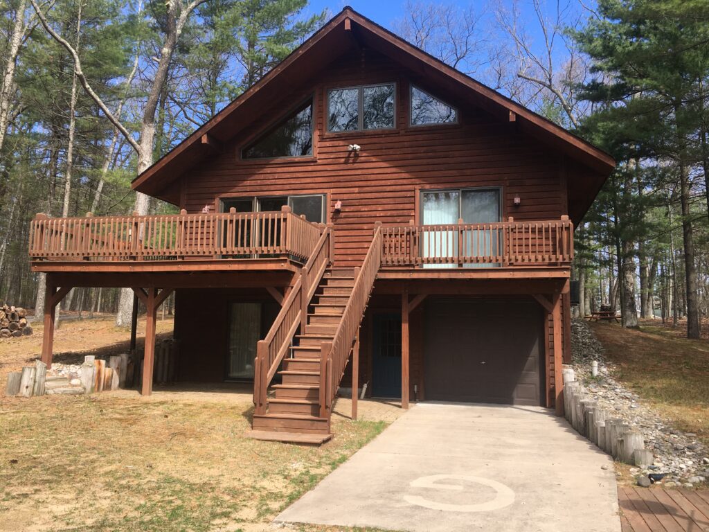 A house with stairs and steps leading to the front door.