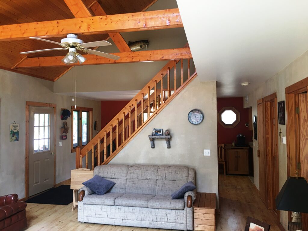 A living room with a couch and stairs