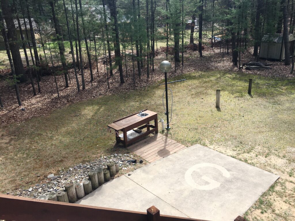 A table and bench in the middle of an area.