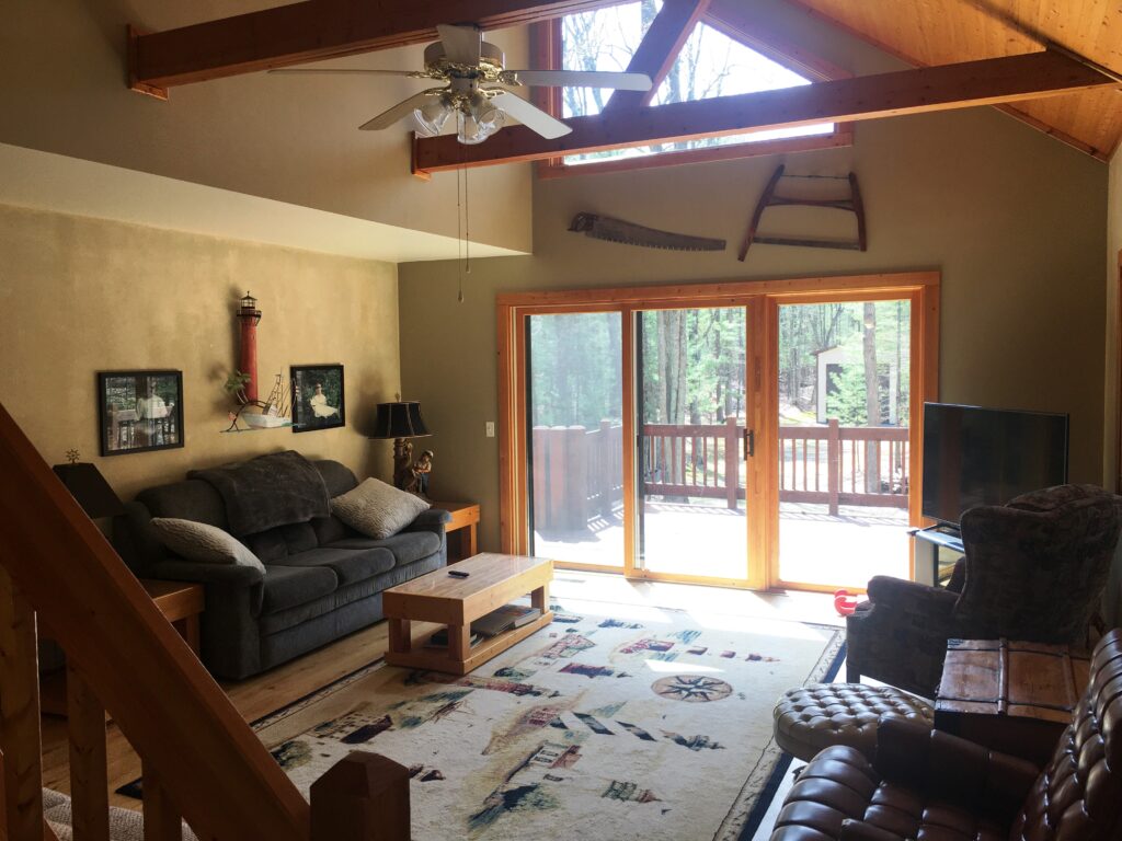 A living room with a couch, chair and table.