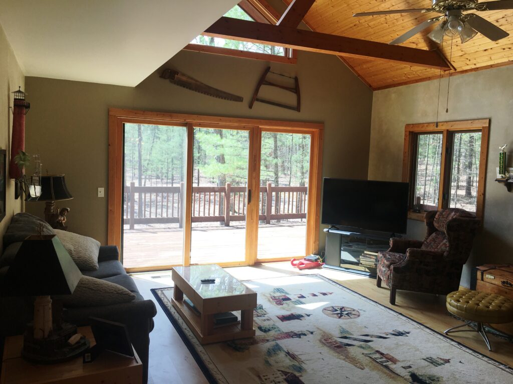 A living room with sliding glass doors and a large window.
