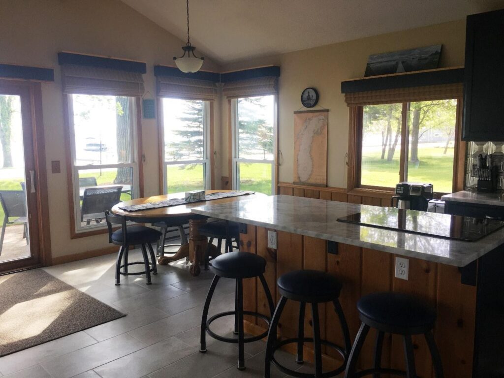 A kitchen with a table and chairs in it