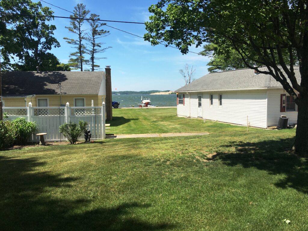 A house with a boat in the background.