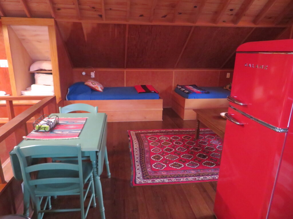 A room with two beds and a table in it