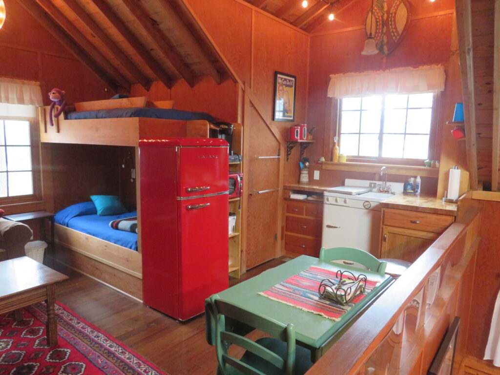 A room with bunk beds and a table in it