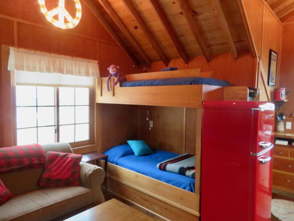 A room with bunk beds and a couch.