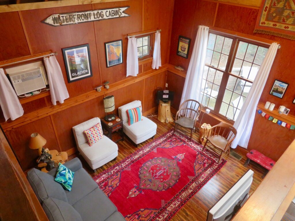 A living room with wood paneled walls and furniture.