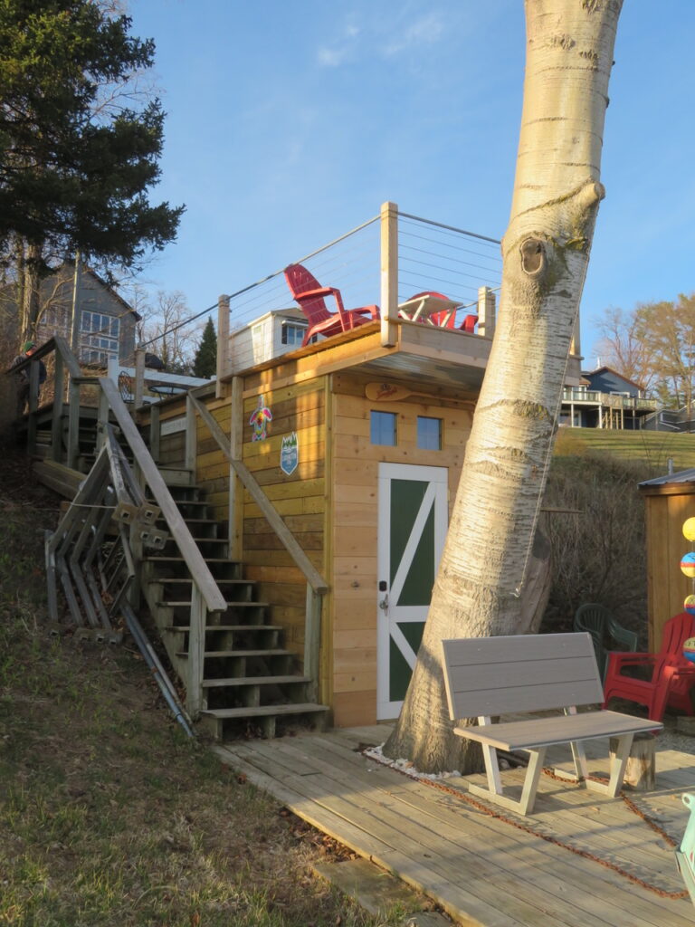 A wooden structure with stairs and a red chair.