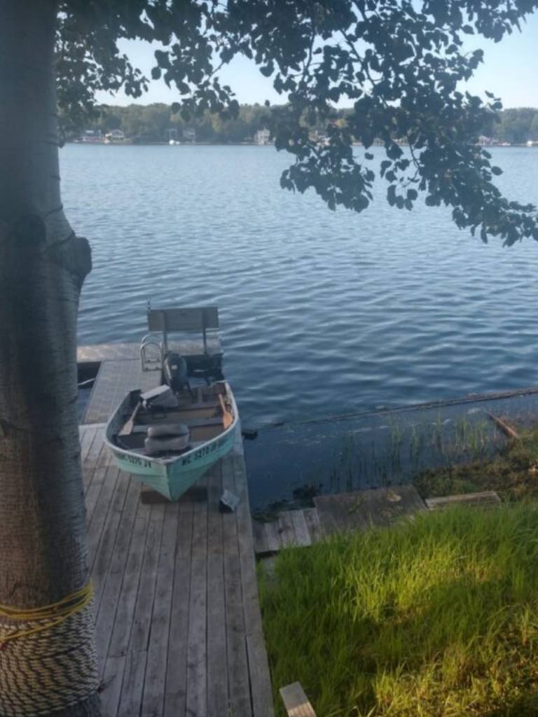 A boat is parked on the dock by the water.