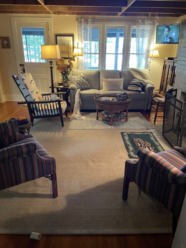 A living room with couches, chairs and lamps.