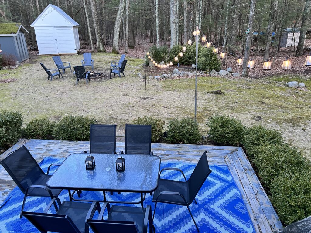 A table and chairs on the patio of a home.