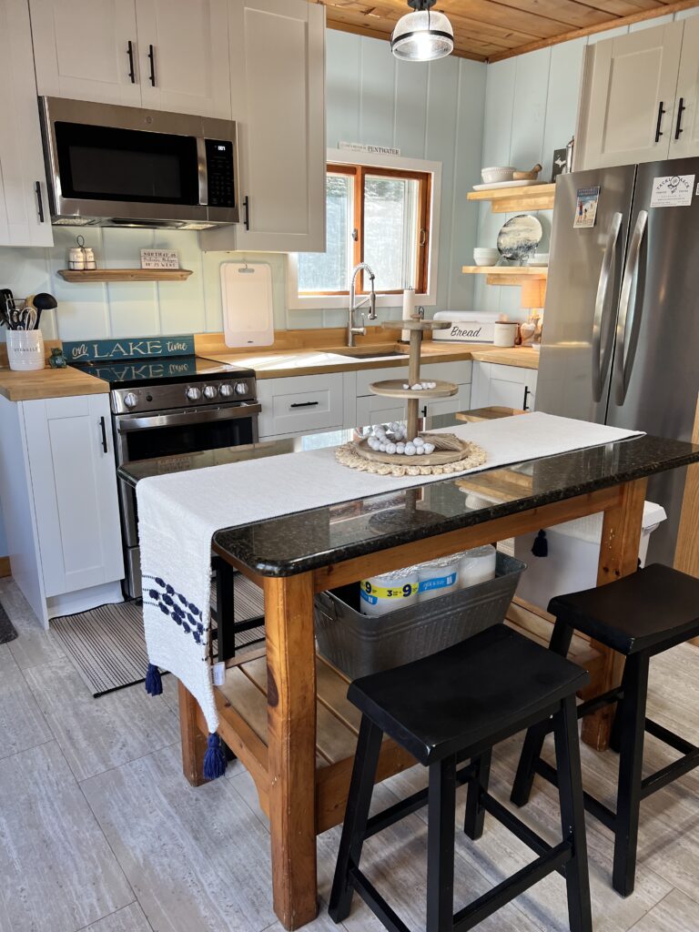 A kitchen with a table and chairs in it