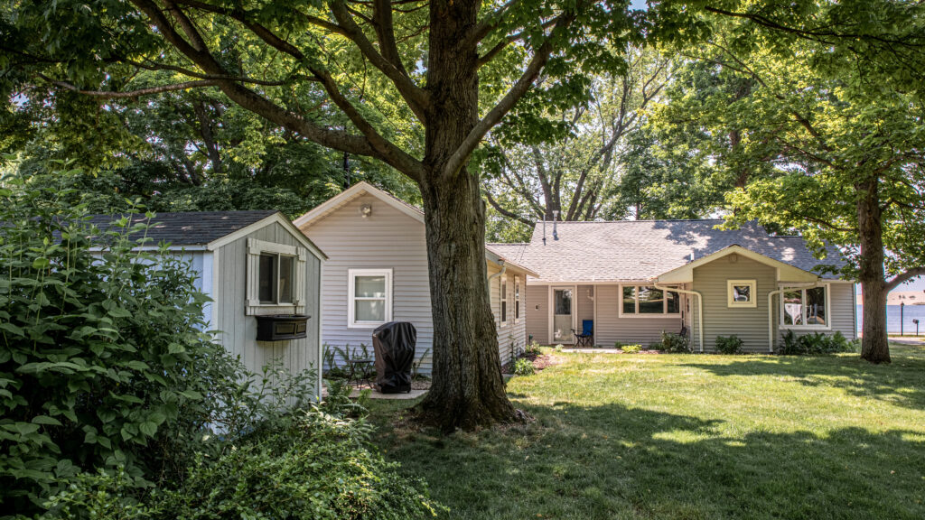 A house with a tree in the background