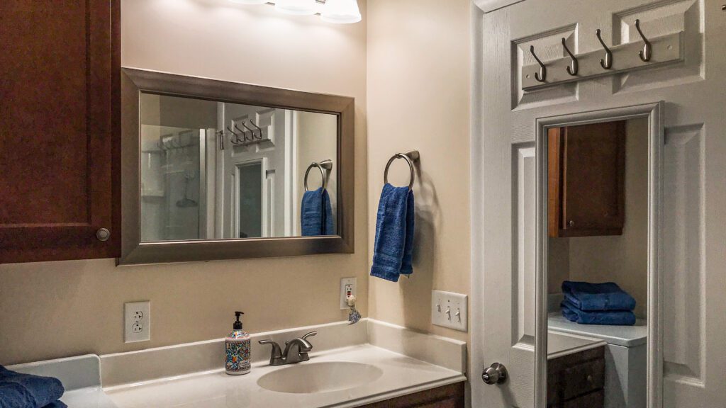 A bathroom with a sink and mirror in it