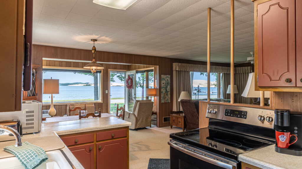 A kitchen with a stove and a refrigerator