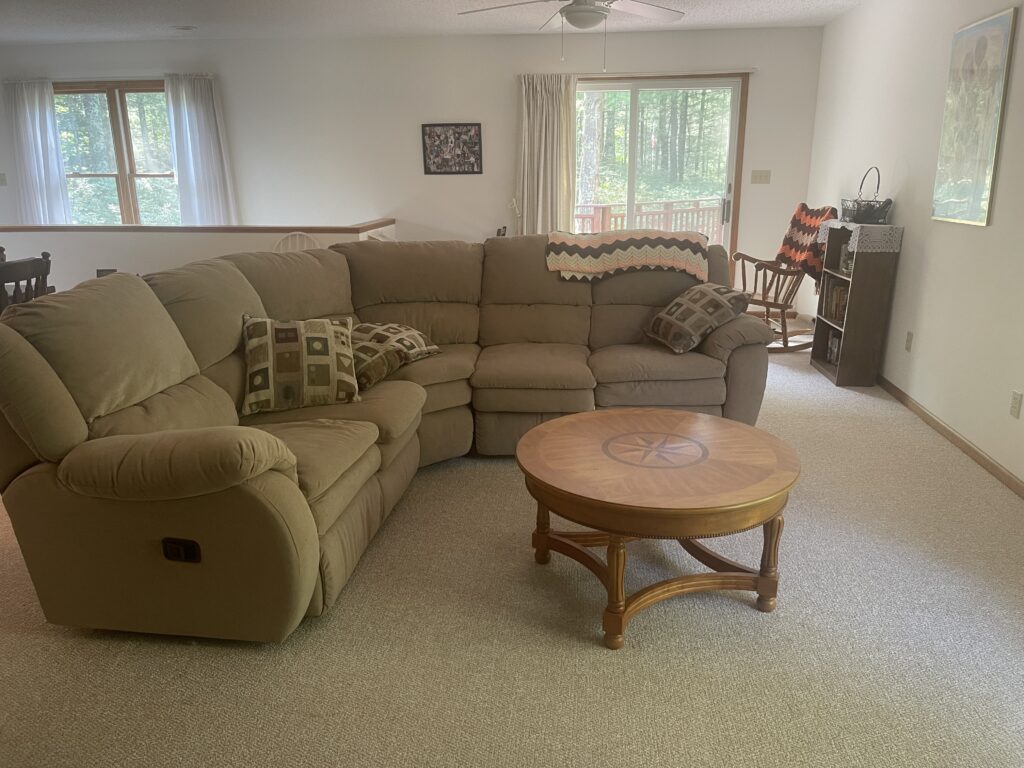 A living room with a couch and a table