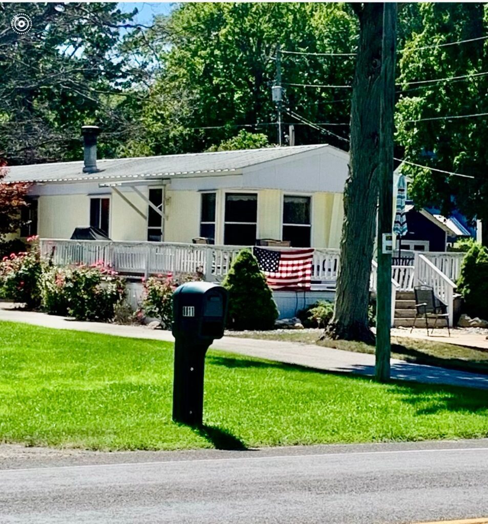 A house with a mailbox on the side of the road.