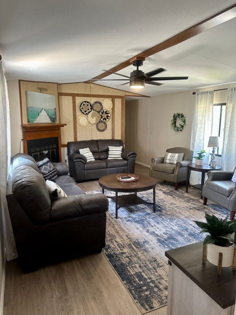 A living room with couches, chairs and tables.