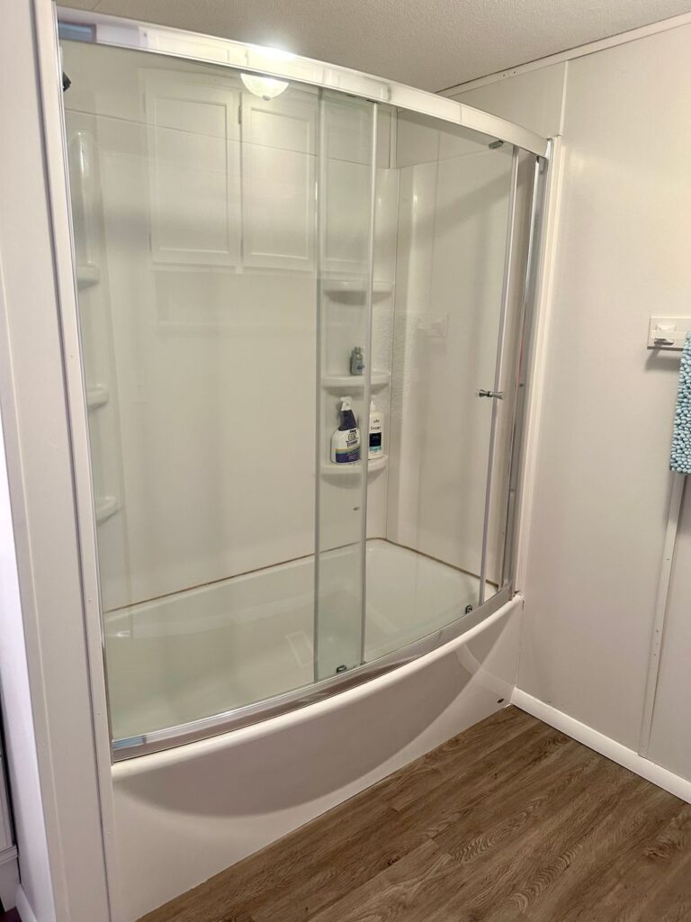 A bathroom with a shower and tub in it